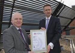 Mark Swales receiving the certificate from Stephen Hudson on the roof of the Cantor Building
